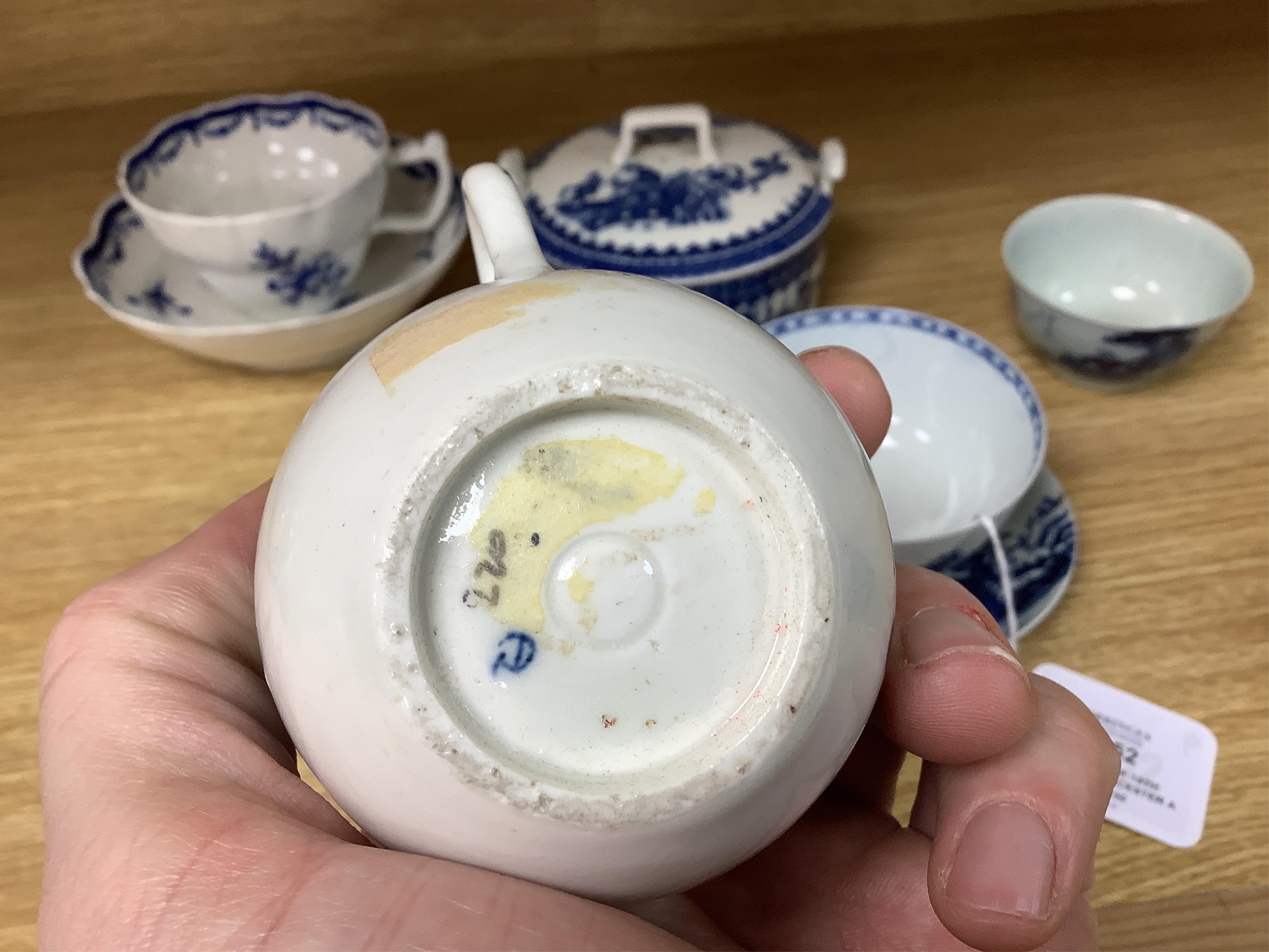 A group of 18th century Worcester and Liverpool porcelain teaware and a Caughley Cormorant fisherman butter tub and cover.
